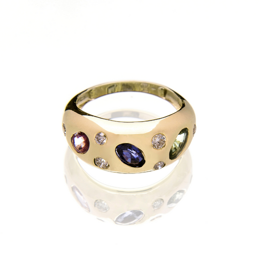 Gold ring with embedded gemstones on a white background