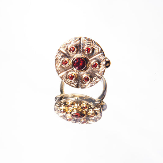 Floral yellow gold ring with garnet by 11th house
