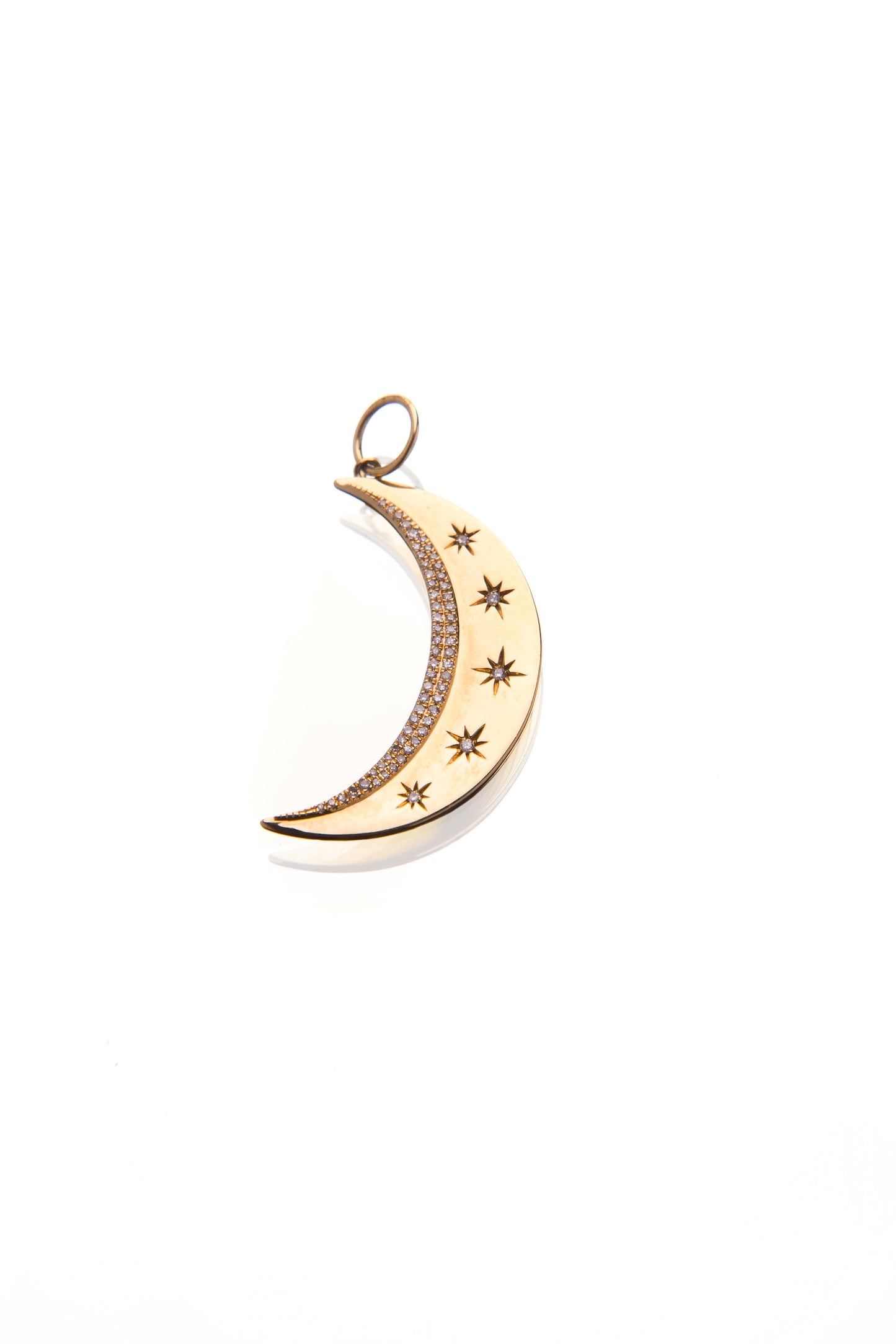 Gold and diamond moon-shaped pendant with star designs by 11th house