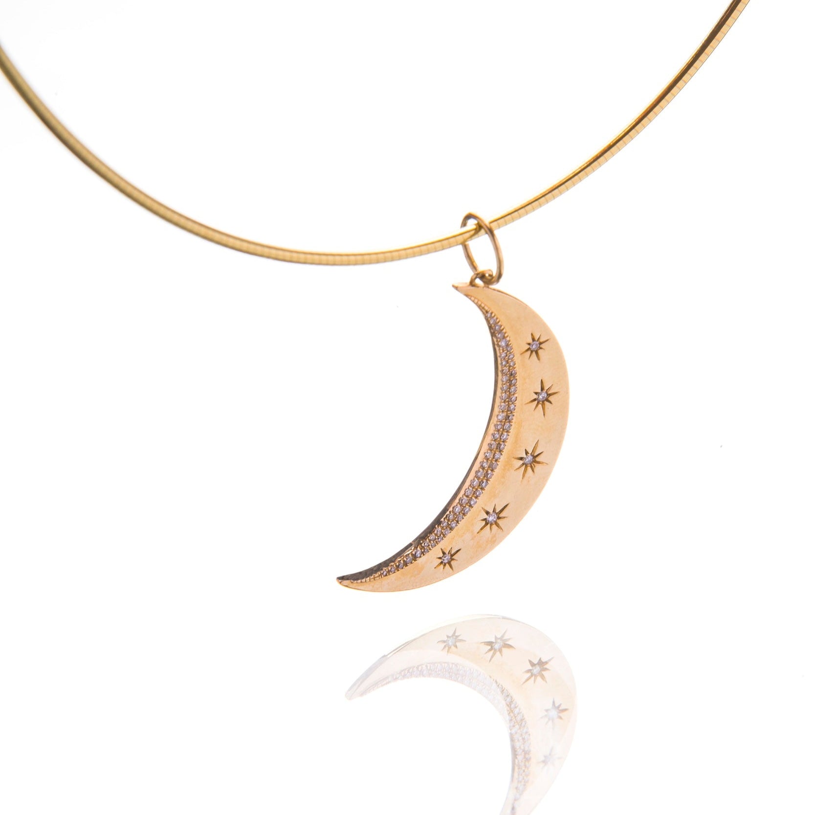 Gold and diamond pendant with a crescent moon on a gold chain