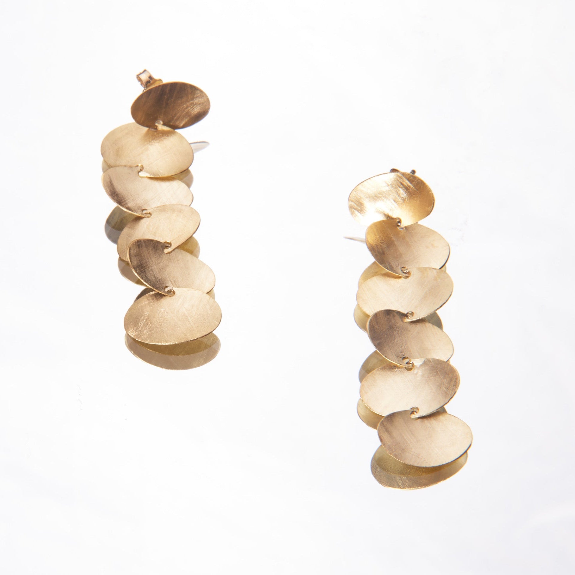 Gold spiral earrings on a white background